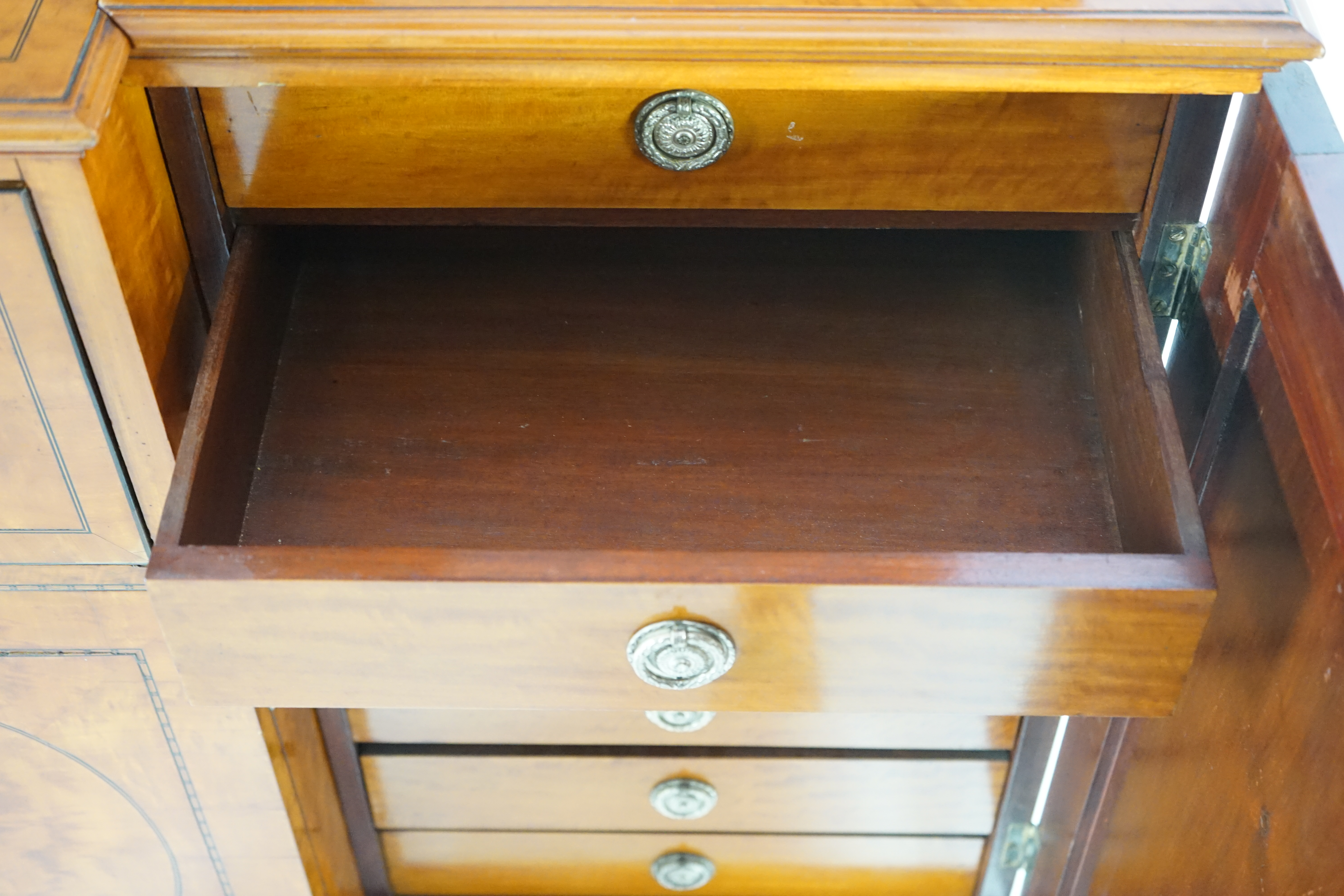 A Sheraton revival ebony strung satinwood breakfront secretaire bookcase